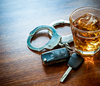 A glass of alcohol and car keys