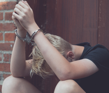 Young boy handcuffed