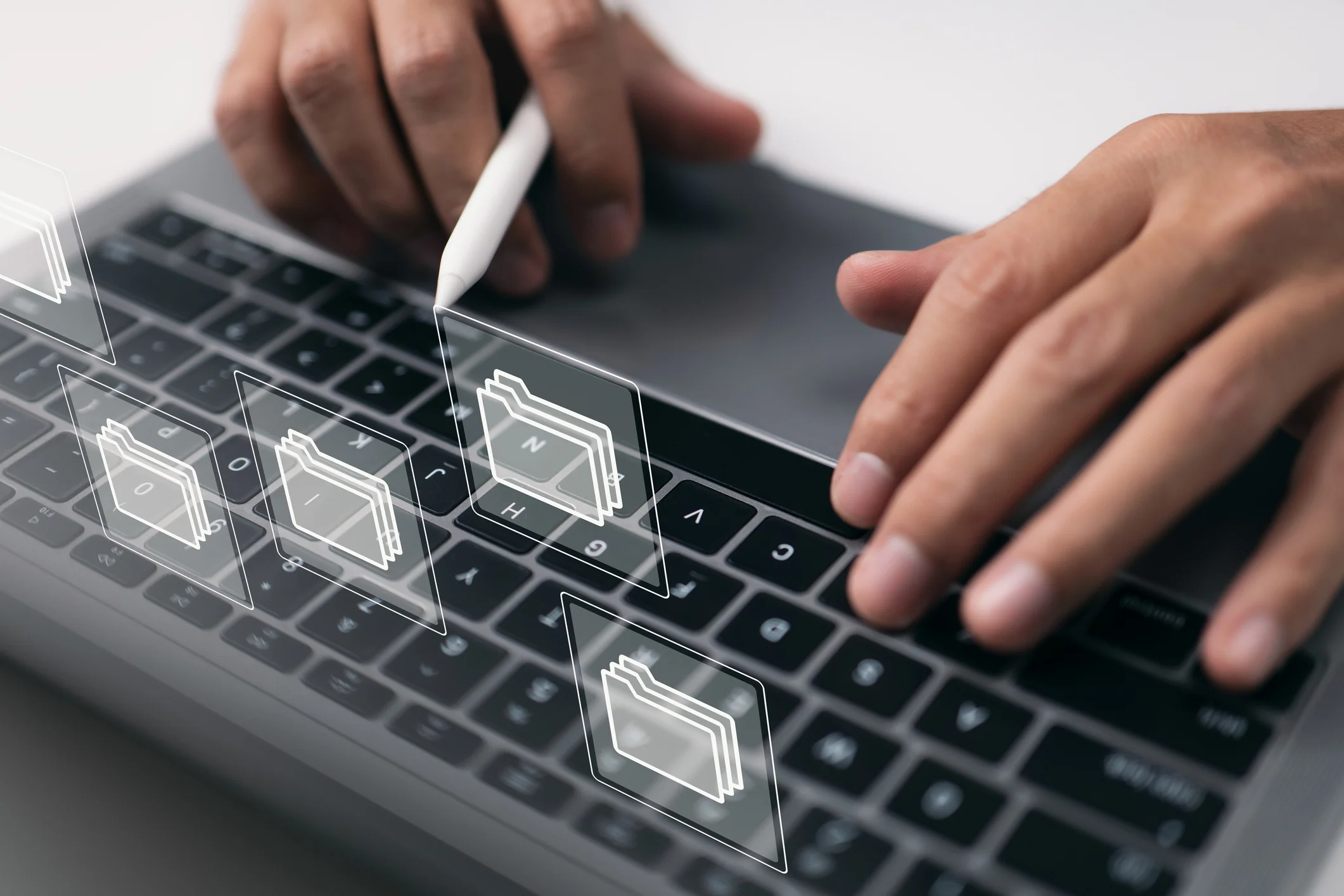 Paperless workplace concept based on e-documents. On a virtual screen, a businessman works on a laptop computer keyboard with electronic document icons.