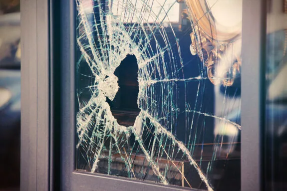 Broken window shop with smashed glass due to robbery